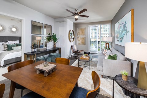 a living room and dining room with a couch and a table